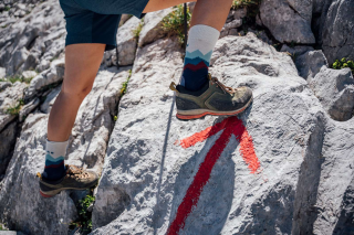 Person steigt auf Fels nach oben